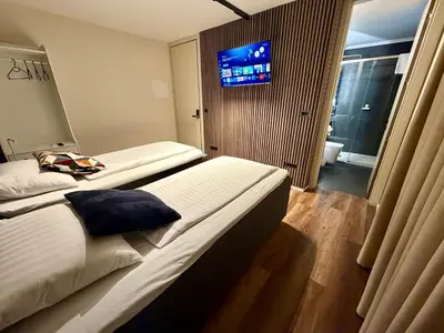 a hotel room with two beds and a flat screen tv at Boutique hotel ZBILJE in Zbilje