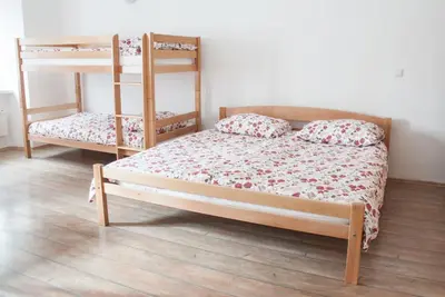 a bedroom with two bunk beds and a wooden floor at Apartment Bon Voyage in Maribor