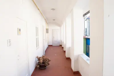 a corridor of an empty hallway with a plant in a pot at Apartment Bon Voyage in Maribor