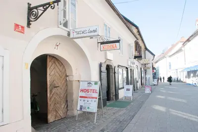 a building with a sign for a market on a street at Apartment Bon Voyage in Maribor