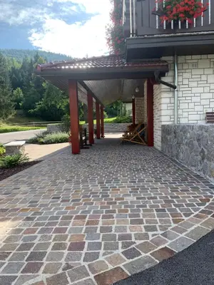 a patio with awning on the side of a building at Žigon Bed & Breakfast in Logatec