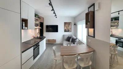 a kitchen and dining room with a table and chairs at Žigon Bed & Breakfast in Logatec