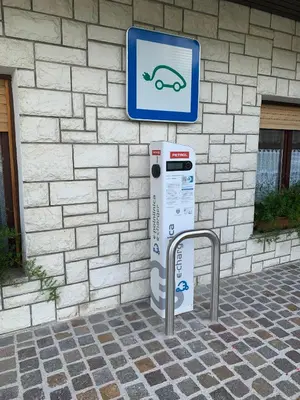 a parking meter with a sign in front of a building at Žigon Bed & Breakfast in Logatec