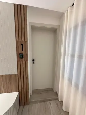 a hallway with a white door and a window at Žigon Bed & Breakfast in Logatec