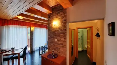 a living room with a table and a dining room at Haus Alexandra Apartment in Bled