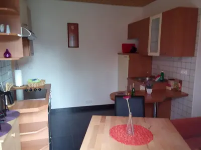 a kitchen with a table with a vase on it at Haus Alexandra Apartment in Bled