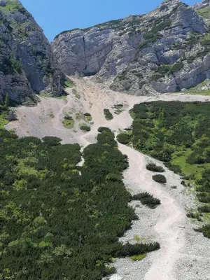 a mountain with a river in the middle at Haus Alexandra Apartment in Bled