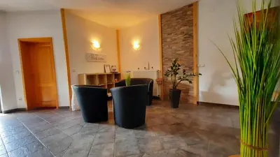 a room with a table and chairs and plants at Haus Alexandra Apartment in Bled