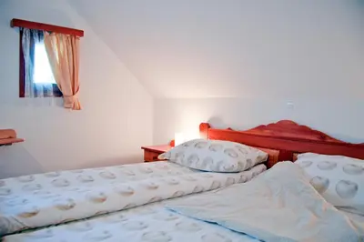 two beds sitting next to each other in a bedroom at Farm stay Bukovje in Ljubno
