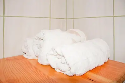 a pile of towels sitting on top of a wooden table at Farm stay Bukovje in Ljubno