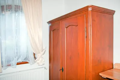 a wooden cabinet sitting next to a window at Farm stay Bukovje in Ljubno