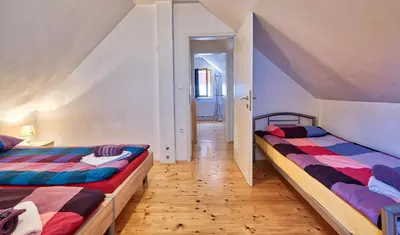 two beds in a room with a hallway at Jacobs Resort House Kranjska Gora in Kranjska Gora