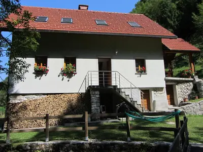 a white house with a red roof at House Dolenja Trebuša in Dolenja Trebuša