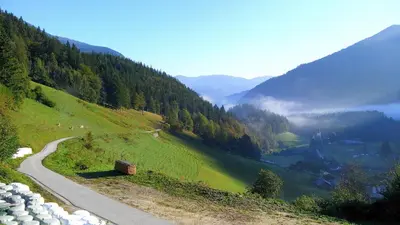 a road on a hill with a view of a valley at Počitniška hiška Kašta in Luče