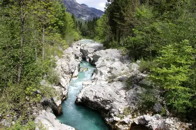 a river in the middle of a rocky canyon at Apartments Tatjana in Bovec