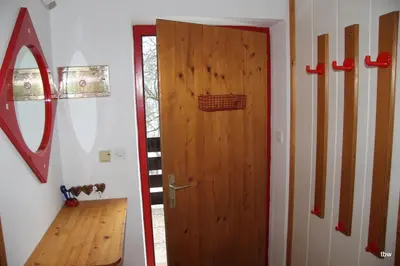 a wooden door in a room with a wooden floor at Apartments Tatjana in Bovec