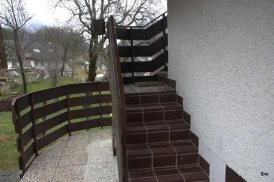 a set of stairs leading up to a fence at Apartments Tatjana in Bovec