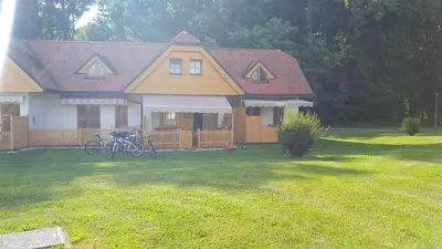 a house with two bikes parked in the yard at Soncnica Apartment in Moravske Toplice
