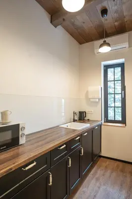 a kitchen with a sink and a microwave at Turn Hostel in Ljubljana