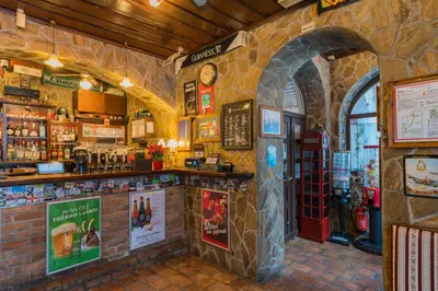 a bar with a red phone booth in a restaurant at Turn Hostel in Ljubljana