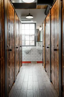 a bathroom with wooden doors and a bathroom with a tub at Turn Hostel in Ljubljana