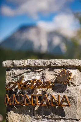 a sign that says eastern mountain on a stone wall at Eco Chalet Astra Montana in Tolmin