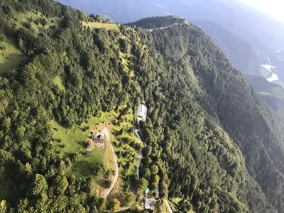 an aerial view of a mountain with trees and a road at Eco Chalet Astra Montana in Tolmin