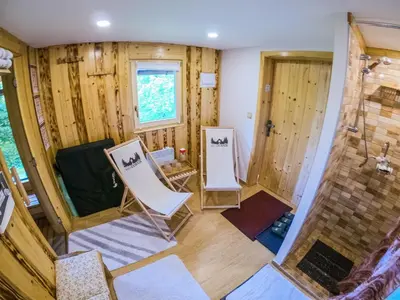a bathroom with two white chairs and a shower at Počitniška hiša Koča Dobnik in Lovrenc na Pohorju