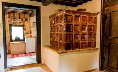 a kitchen with a large glass block wall at Počitniška hiša Koča Dobnik in Lovrenc na Pohorju