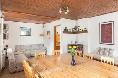 a living room with a table and a couch at Hostel Mama Minka in Bohinj
