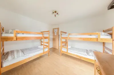 a room with three bunk beds in it at Hostel Mama Minka in Bohinj