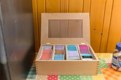 a wooden box filled with different colored papers at Hostel Mama Minka in Bohinj