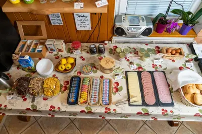 a table with different types of food on it at Hostel Mama Minka in Bohinj