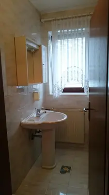 a bathroom with a sink and a window at Apartment Vrtacnik in Štefanja Gora