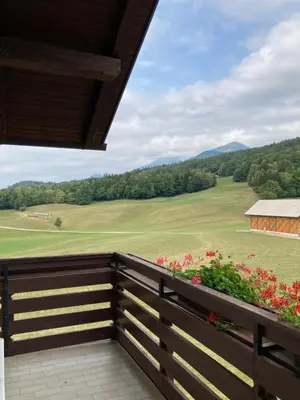 a balcony with a view of a field and mountains at Apartment Vrtacnik in Štefanja Gora