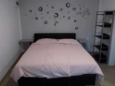 a bedroom with a bed with a white comforter at Apartment Pri Ruscu in Tolmin