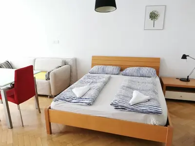 a bedroom with a bed with two pillows on it at City centre studio with a balcony and free parking in Ljubljana