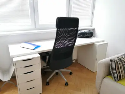 a desk with a chair in a room with a window at City centre studio with a balcony and free parking in Ljubljana