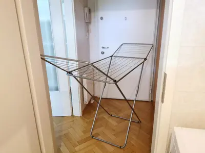 a metal shelf in a hallway with a door at City centre studio with a balcony and free parking in Ljubljana