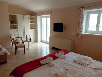 a bedroom with a large bed with towels on it at Hotel Kozana in Dobrovo