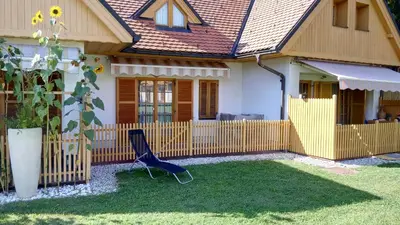 a blue chair in front of a house at Apartment Pika in Moravske Toplice
