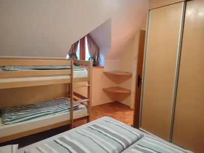 a small room with two bunk beds and a closet at Apartment Pika in Moravske Toplice