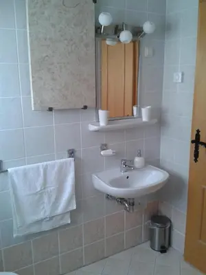 a bathroom with a sink and a mirror and a towel at Apartment Pika in Moravske Toplice