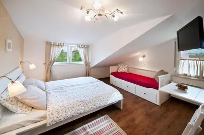 a small bedroom with a bed and a tv at Hotel SAMARIN Črnomelj in Črnomelj