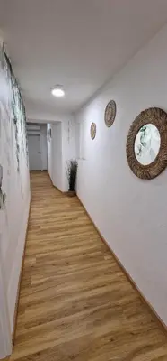a hallway with white walls and a wooden floor at Hotel SAMARIN Črnomelj in Črnomelj