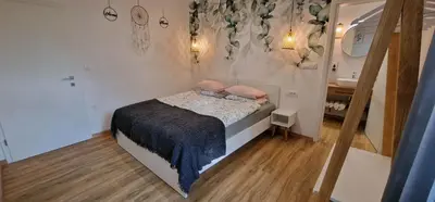 a small bedroom with a bed and a sink at Hotel SAMARIN Črnomelj in Črnomelj