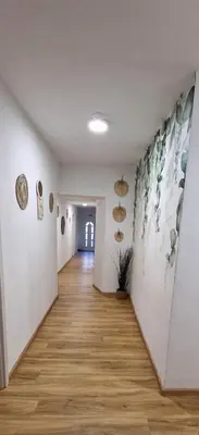 a hallway with paintings on the walls of a room at Hotel SAMARIN Črnomelj in Črnomelj