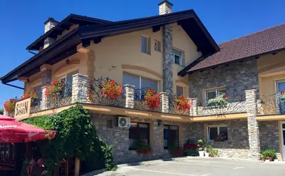 a building with flower boxes on the balconies at Hotel SAMARIN Črnomelj in Črnomelj