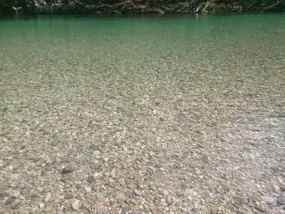 a large body of water with rocks in it at Apartment Lapanja in Slappe dʼIdria