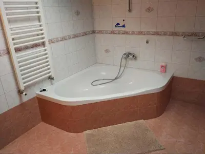 a bath tub with a faucet in a bathroom at Apartment Lapanja in Slappe dʼIdria